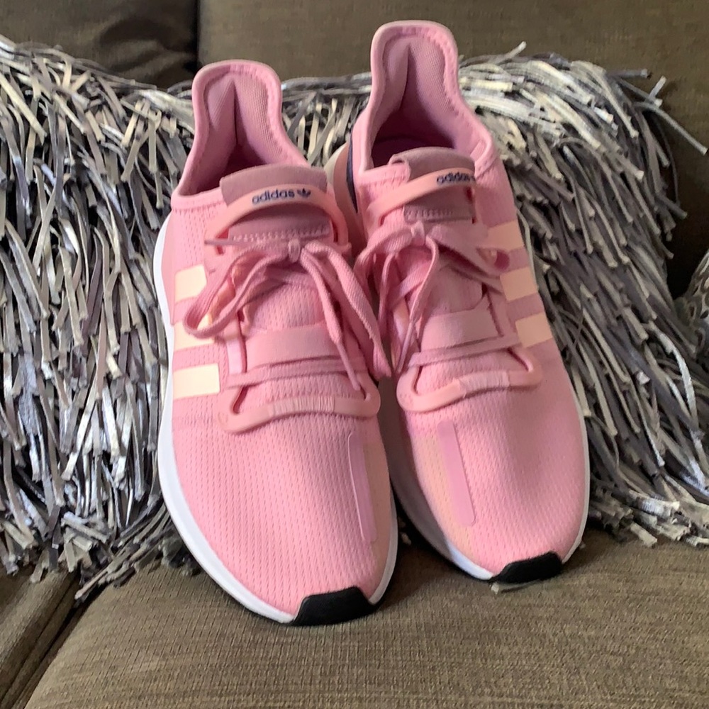Woman’s pink adidas sneakers